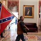 Un partidario del presidente Donald Trump lleva la bandera confederada en el asalto al Capitolio de los Estados Unidos, en Washington.