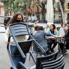 Treballadors del restaurant Amélie de la plaça de la Vila recollint taules i cadires amb gent encara menjant, e