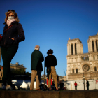 La gent amb mascaretes davant la catedral de Notre-Dame de Paris durant la pandèmia del coronavirus