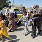 Mujeres con sus hijos intentan llegar al aeropuerto Hamid Karzai de Kabul.