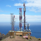 Imagen de archivo de unas antenas de telecomunicaciones a una zona de costa.