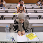 Alumnes enganxen l'etiqueta identificativa abans de començar l'examen de castellà de les PAU, al Campus Catalunya de la URV, a Tarragona.