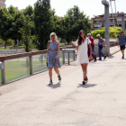 Dos chicas sin mascarilla paseando por la pasarela del río Segre en Lleida.