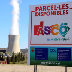 Primer plano de un cartel de promoción del polígono industrial de Ascó con la central nuclear al fondo.