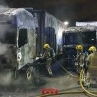 Els bombers duent a terme les tasques d'extinció dels dos camions.