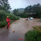 Els Bombers retirant un cotxe que s'ha emportat l'aigua al riu Cardener, a Súria