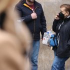 Una dona a l'exterior del Clínic parant per telèfon amb la mascareta posada.