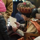 El patge reial del Rei ros recollint la carta d'una nena a la plaça de la Llibertat.