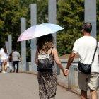 Una dona camina amb un paraigua pel calor.