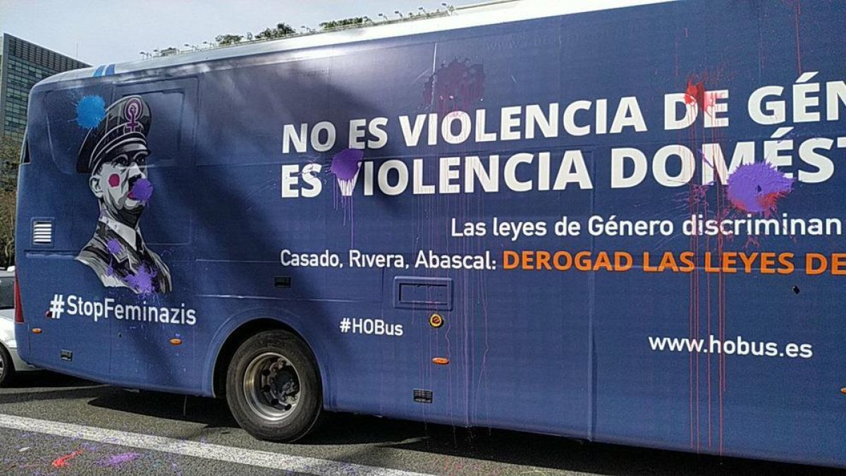 Imatge de l'autobús d'Hazte Oír amb taques de pintura lila i pintades.