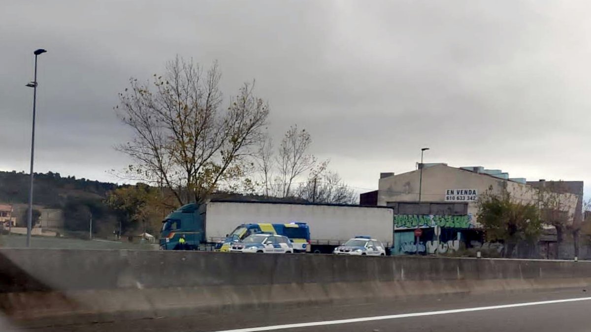 Las patrullas de Tráfico de los Mossos d'Esquadra con el tráiler que conducía el camionero detenido, en su punto de la C-66 donde consiguieron pararlo.