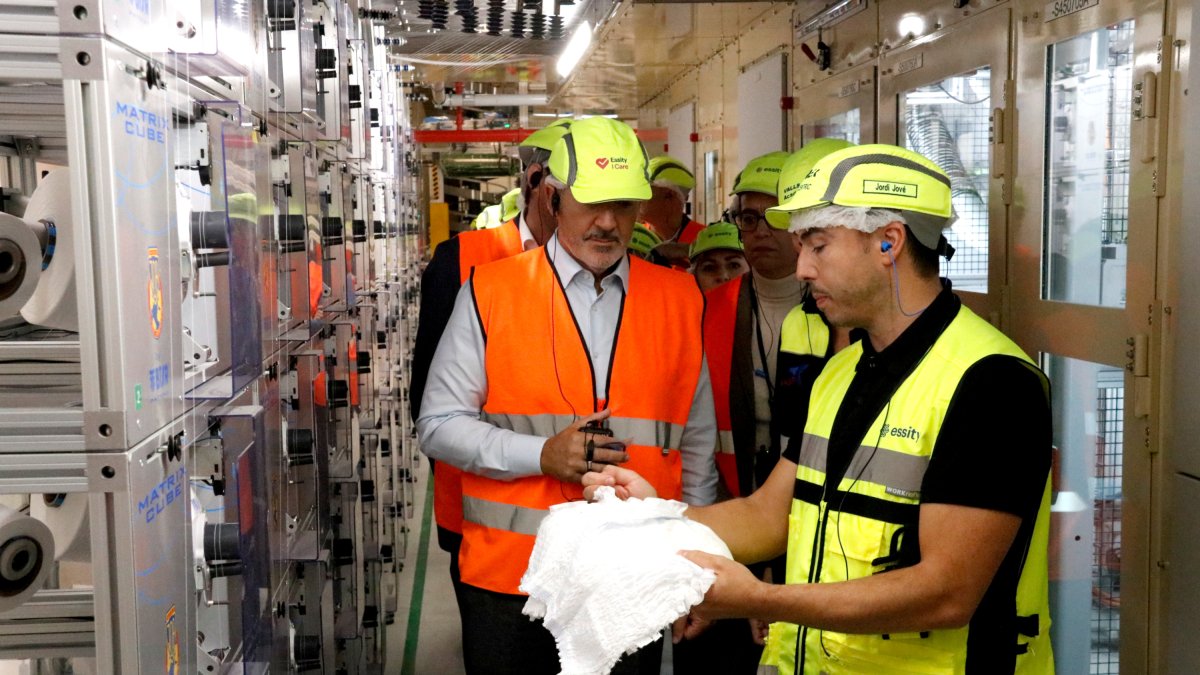 Un operari d'Essity ensenya un bolquer al conseller d'Empresa i Treball, Miquel Sàmper