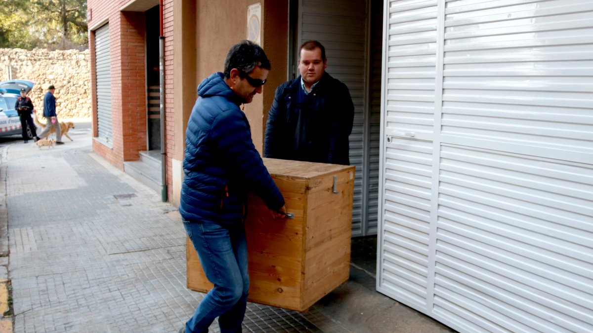 Dues persones treuen els nans de Montblanc del taller Avall de Reus.