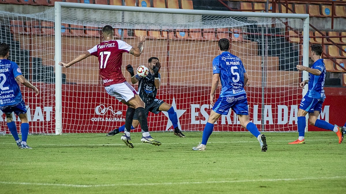 El portero del Ourense, Raúl Marqueta, deteniendo un tiro a Pablo Fernández en el primer partido de la Primera Federación en un Nou Estadi Costa Daurada sin público.