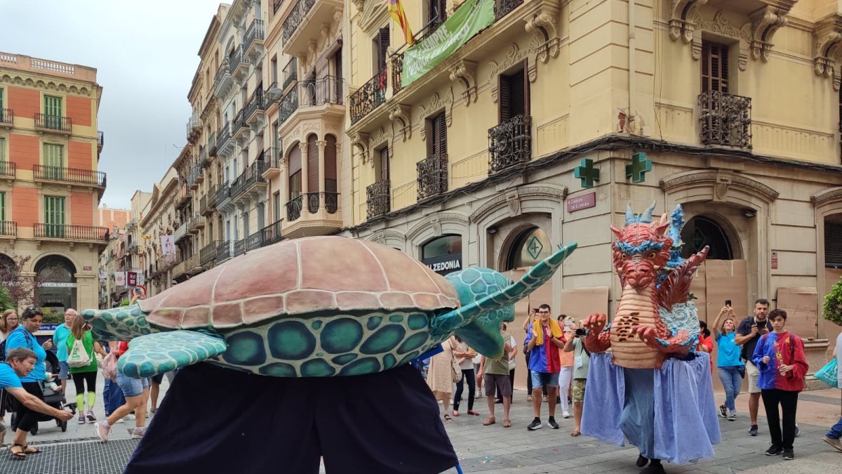 Fotografía del Superadrac y la Tortuga del Vendrell bailando en la plaza de Prim