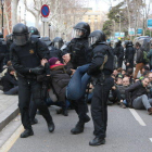Un grupo de antidisturbios de los Mossos D'Esquadra desalojan una mujer concentrada delante del TSJC.