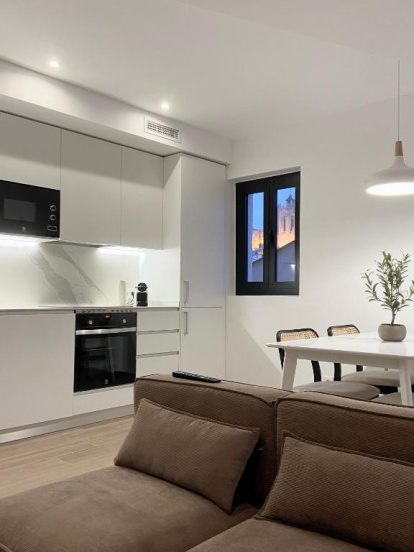 Imagen de la cocina y el comedor de uno de los apartamentos Vigablanca de Tarragona, con vistas en la catedral de Tarragona.
